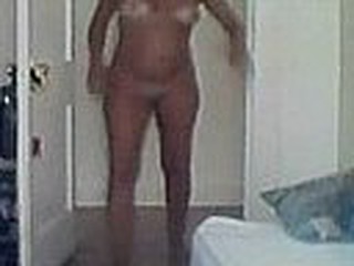 Mature woman gets caught walking around the room completely naked, she doesn't suspect that there is a hidden camera in the room filming her tanned body.