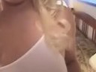 Blonde busty hussy in sexy white lingerie fellates man's hard might dick, putting it deeply in her mouth.