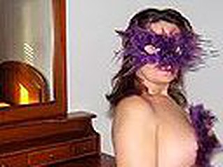 Chubby Spanish mature woman in cute bra with multicolor heart shaped patterns blows cock wearing a bizarre violet feather mask and listening to Santana's rendition of 'Black Magic Woman'.